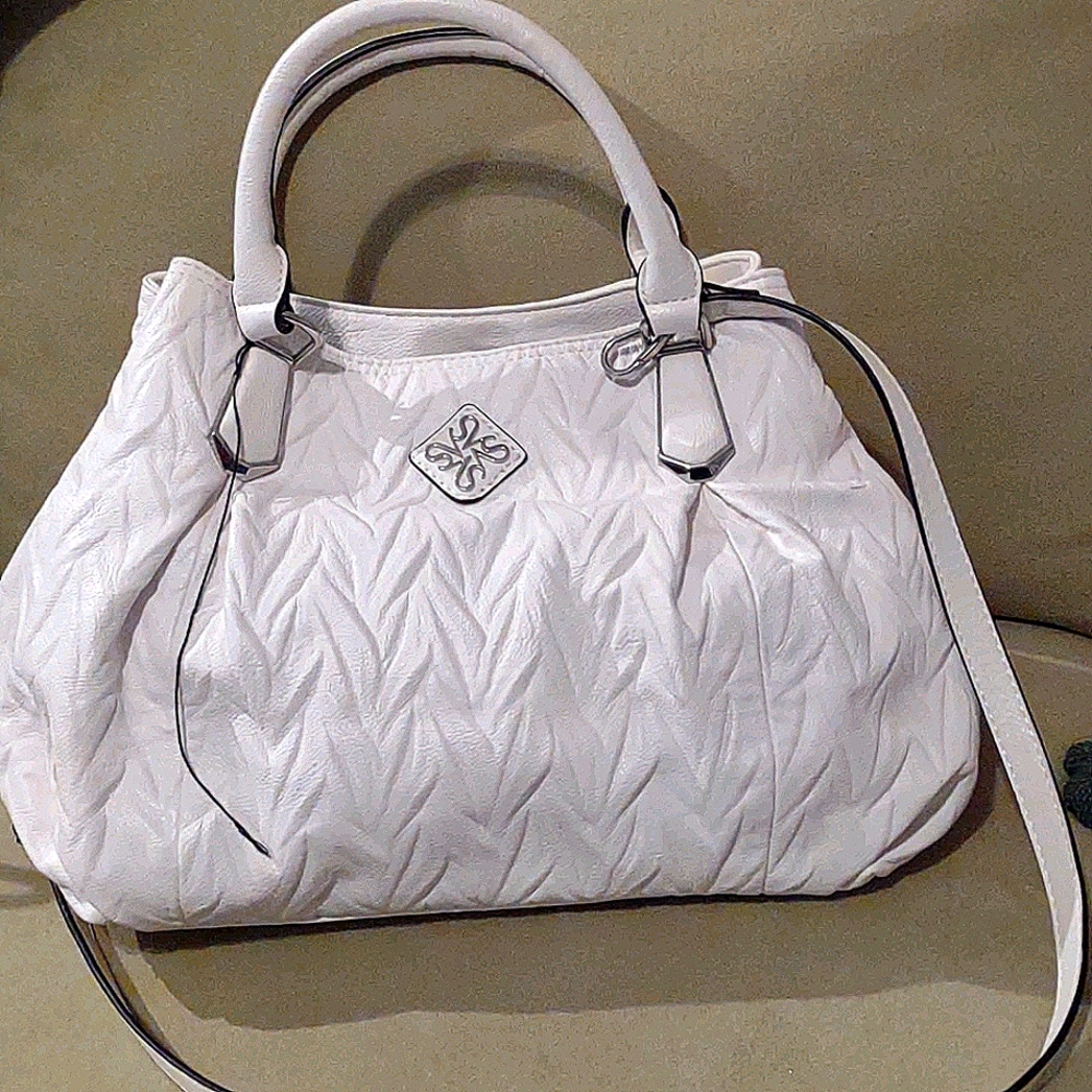 This is a Vera Wang white leather handbag